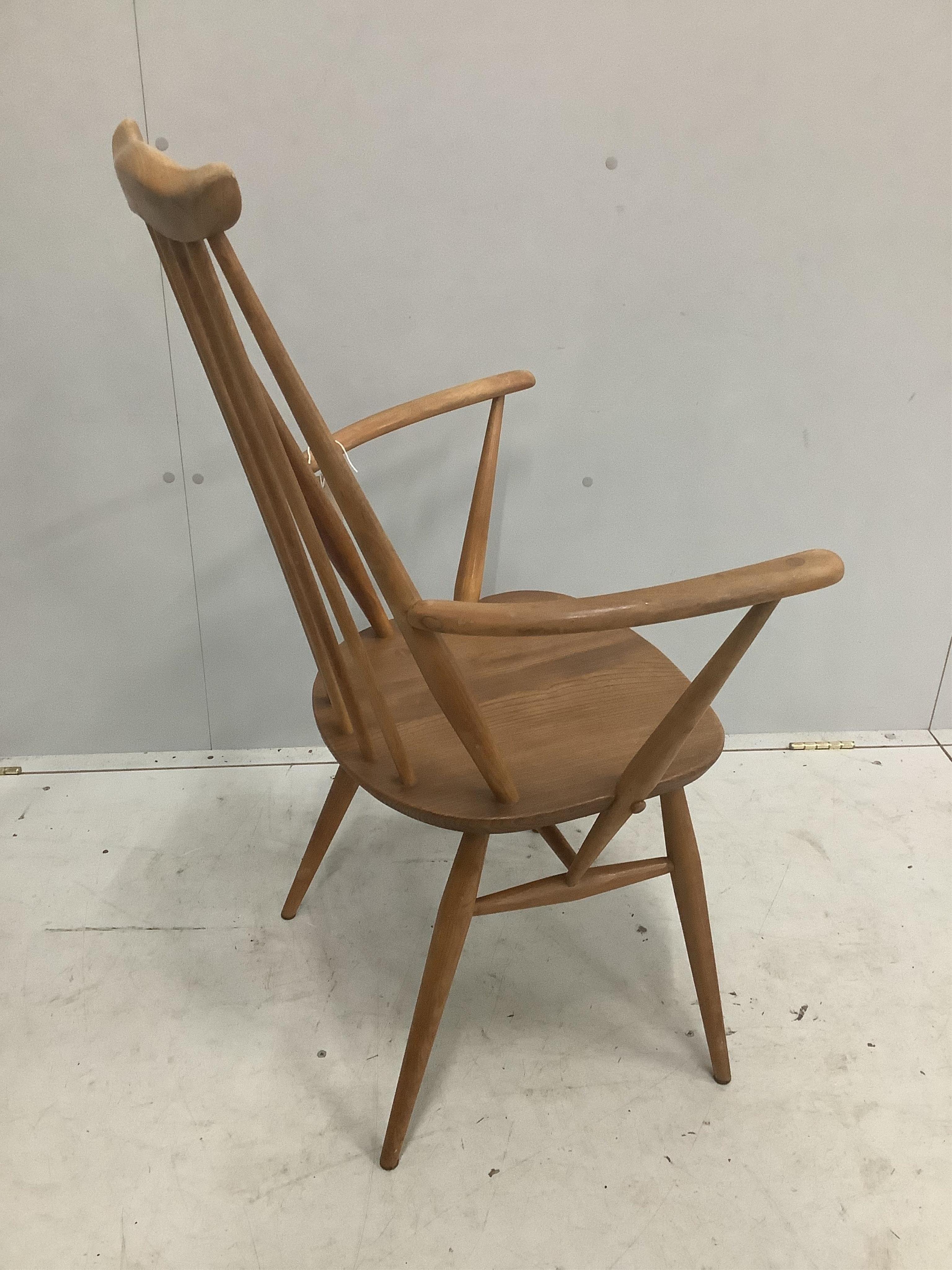 An Ercol Goldsmith's comb back elbow chair, width 61cm, depth 41cm, height 98cm. Condition - fair